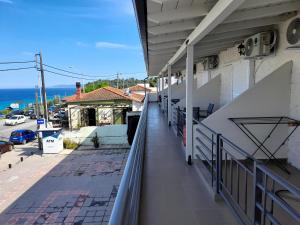 a balcony of a building with a view of the ocean at Johny's Studios in Kallithea Halkidikis +40 photos