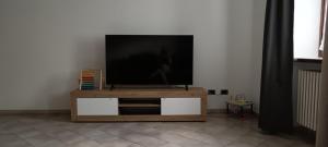 a flat screen tv sitting on top of a wooden entertainment center at Nonna Lidie in Aymavilles