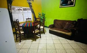 a living room with a couch and a table at Apartamento el Amigo in Panajachel +12 photos