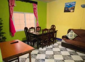 a living room with a table and a dining room at Apartamento el Amigo in Panajachel