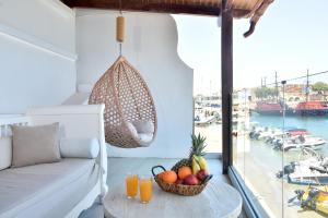 a bowl of fruit on a table in a room with a window at Aqua Vero Seaside Residence in Hersonissos