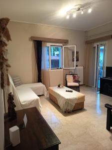 a hotel room with two beds and a living room at Akratas Brothers House in Akrata