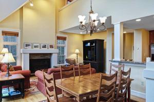 a dining room and living room with a wooden table at Castle Hill Condo in Cavendish