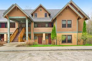 a large house with a staircase in front of it at Castle Hill Condo in Cavendish