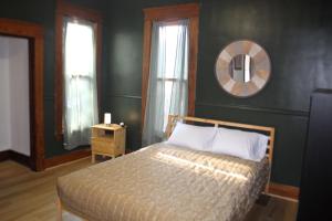 a bedroom with a bed and a mirror on the wall at The Polished Plank in Kokomo