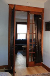 an open door to a living room with a couch at The Polished Plank in Kokomo