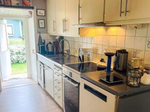 a kitchen with a sink and a stove top oven at 4 star holiday home in SÖLVESBORG in Sölvesborg