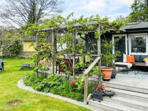 a greenhouse with plants in it on a deck at 4 star holiday home in SÖLVESBORG in Sölvesborg +24 photos