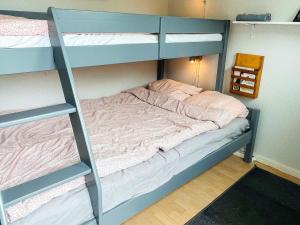 a bunk bed in a room with a ladder at 4 star holiday home in SÖLVESBORG in Sölvesborg