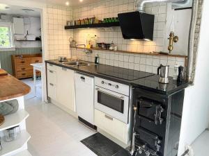 a kitchen with a stove and a sink at 4 star holiday home in TORHAMN-By Traum in Torhamn +31 photos
