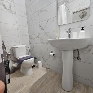 a bathroom with a sink and a toilet at Garden Room with Private Patio Salamis in Eantio +29 photos