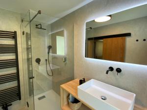 a bathroom with a sink and a shower at Ferienhaus Eichenseer Gallzein - Alleinlage mit Garten, Wald & Bergblick in Gallzein