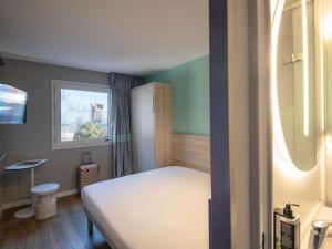 a small room with a bed and a window at ibis budget Nice Aeroport in Nice +53 photos