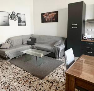 a living room with a couch and a table at Koras 142 in Sennori