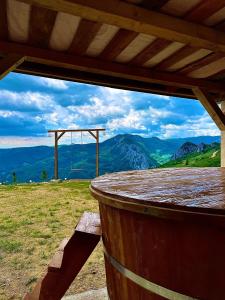 a view of the mountains from a wooden table at Cabana AxD in Cotorăşti