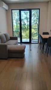 a living room with a couch and a table at Ureki Sun Estate in Ureki