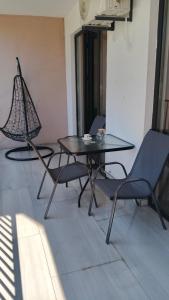 a dining table and chairs in a room at Ureki Sun Estate in Ureki +5 photos