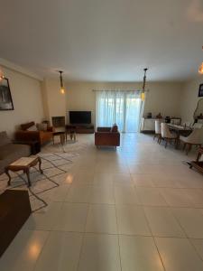 a large living room with couches and a tv at Superbe Appartement Bord de mer in Bouznika