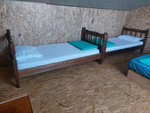 two twin beds in a room with a wall at Kućica Dva Dječaka in Ulcinj