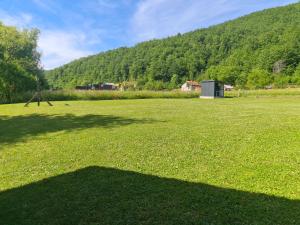a large field of grass with a mountain in the background at Kamp SAN in Zaglavica