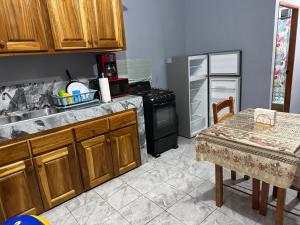 a kitchen with a sink and a stove and a table at Tees Place in Hopkins +2 photos