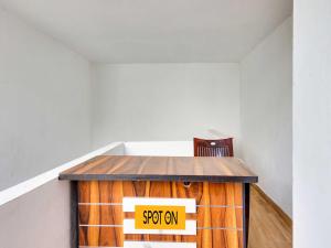 a table in a room with a sign on it at Hotel O Hills Land in Warangal +30 photos