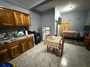 a kitchen with a table and a room with a bed at Tees Place in Hopkins