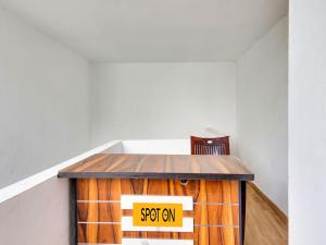 a table in a room with a sign on it at Hotel O Hills Land in Warangal