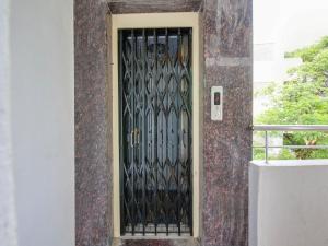 a door with a iron gate on a building at Hotel O Hills Land in Warangal