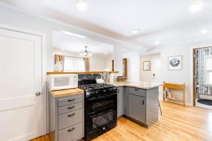 eine Küche mit Herd und Mikrowelle in der Unterkunft Casa Okemo in Ludlow