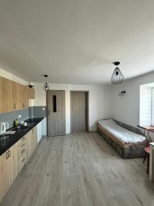 a kitchen with a bed in the middle of a room at Królewska Przystań in Kamienica Królewska