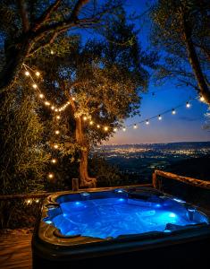 a jacuzzi tub sitting on a deck with lights at Aura Toscana Boutique in Monsummano Terme +149 photos