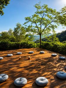 a garden with manyental objects on a wooden deck at Aura Toscana Boutique in Monsummano Terme