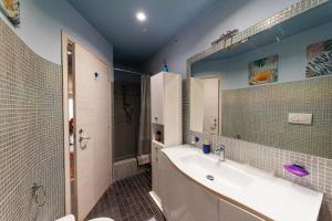 a bathroom with a sink and a toilet and a mirror at AuraVista in Montefiascone +30 photos