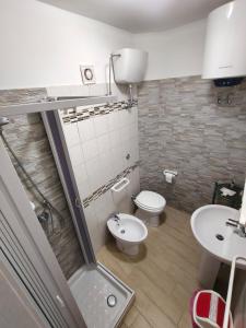 a bathroom with a toilet and a sink at Scilla Chianalea Suite Mare1 in Scilla