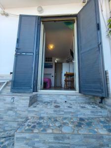 an open door of a house with a window at Scilla Chianalea Suite Mare1 in Scilla