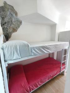 a bunk bed in a room with a red blanket at Scilla Chianalea Suite Mare1 in Scilla