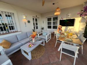 a living room with a couch and a table at VILLA AMIRA ,Marbella Estepona in Benahavís