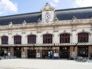a building with a clock tower on top of it at ibis budget Bordeaux Centre - Gare Saint Jean in Bordeaux
