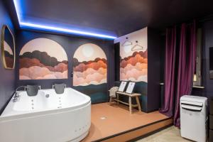 a bathroom with a tub and a sink at Doux Pavillon - 1001 nuits - Jaccuzi in Mulhouse +9 photos