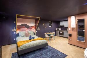 a bedroom with a large bed in a room at Doux Pavillon - 1001 nuits - Jaccuzi in Mulhouse