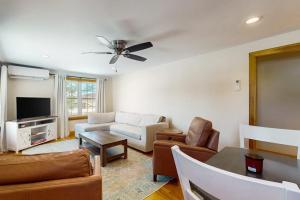 a living room with a couch and a table at Strollski Cottage in Ludlow