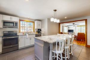 a kitchen with a island with bar stools at Strollski Cottage in Ludlow