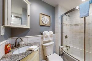a bathroom with a toilet and a sink and a shower at Strollski Cottage in Ludlow +32 photos
