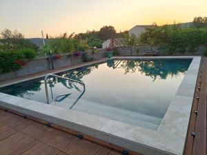 a swimming pool with a stairway leading into it at La cabane des jours heureux in Saint-Laurent-de-Carnols +11 photos