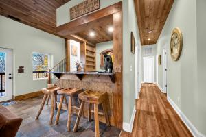 a kitchen with a bar in a home with wooden ceilings at Meadow View in Banner Elk +28 photos