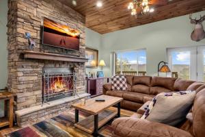 a living room with a couch and a fireplace at Meadow View in Banner Elk