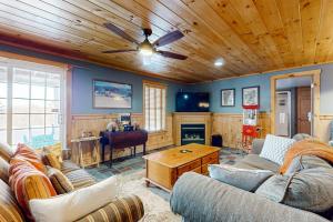 a living room with a couch and a wooden ceiling at Wish Upon A Star in Windham