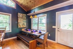 a dining room with blue walls and a wooden ceiling at Misty Mountain Cabin in Lenoir +12 photos