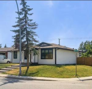 a house on the corner of a street at 2 bedroom Cozy Secondary-Basement suite in Calgary
